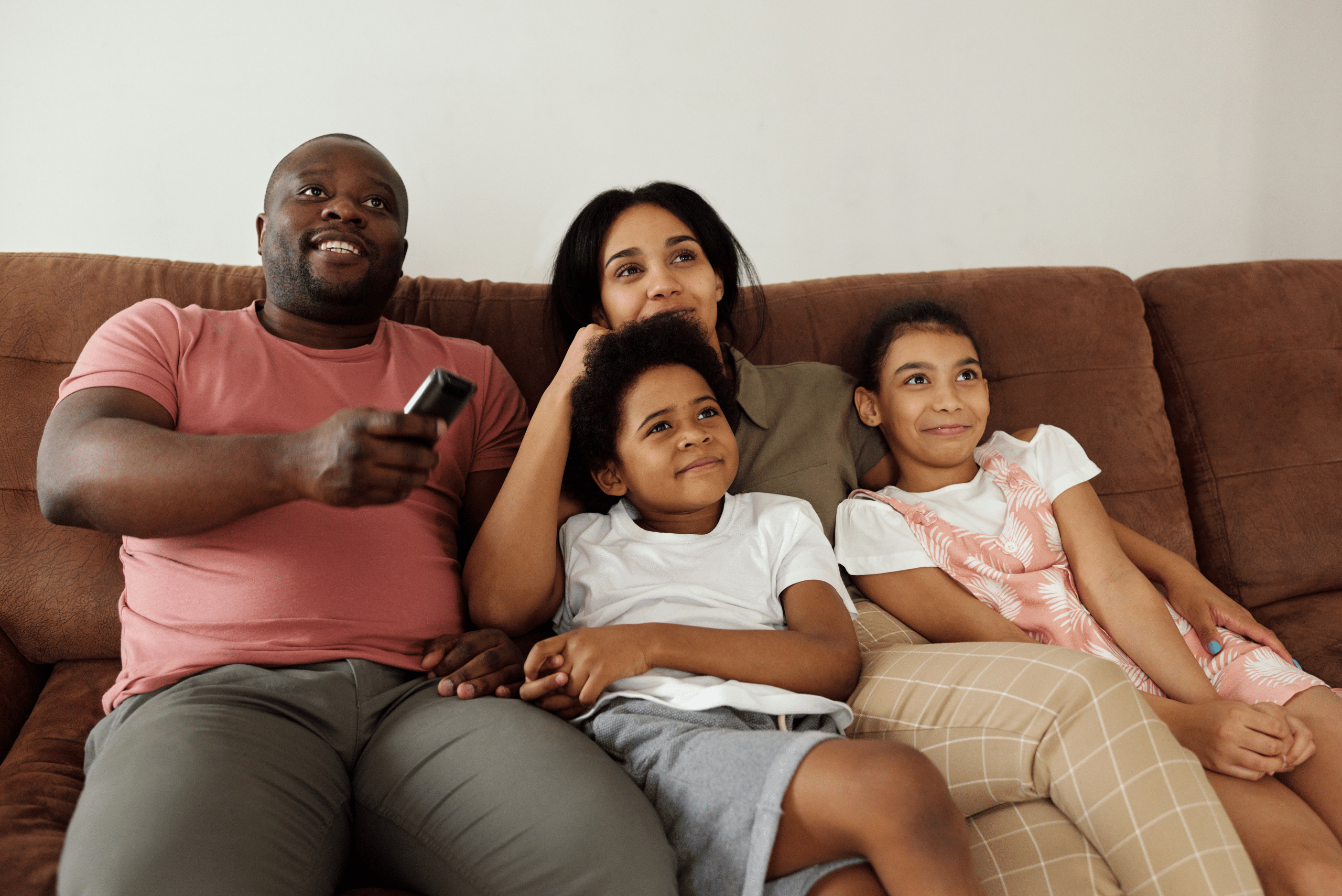 Family sitting together on sofa; Parent's Guide to Digitally Responsible Youth
